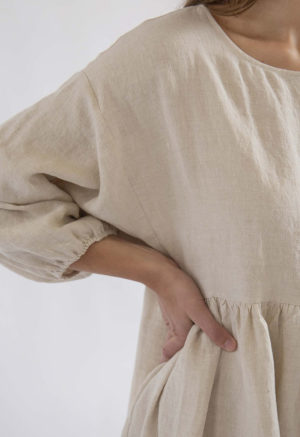 woman standing on white backdrop in oatmeal linen balloon sleeve midi oversized dress