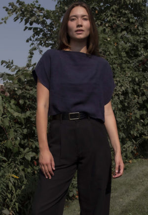 woman in navy linen boatneck short sleeve top with black slack