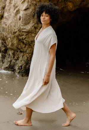 woman on the beach in cream linen v-neck short sleeve midi dress
