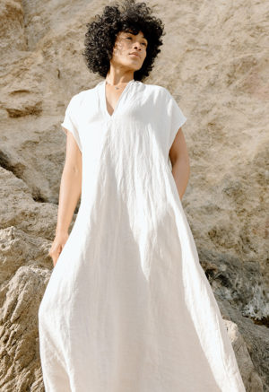 woman on the beach in cream linen v-neck short sleeve midi dress