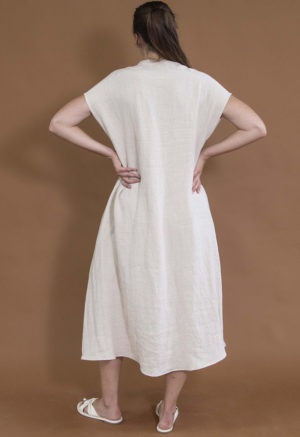 woman wearing oatmeal linen line v-neck short sleeve midi length swing dress