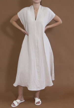 woman wearing oatmeal linen line v-neck short sleeve midi length swing dress