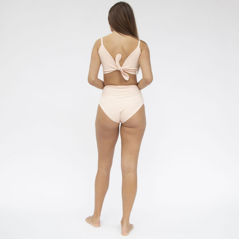 Back shot of straight size model in Two-Way Top and High-Waisted Bikini Bottoms in Petal Pink Rib.