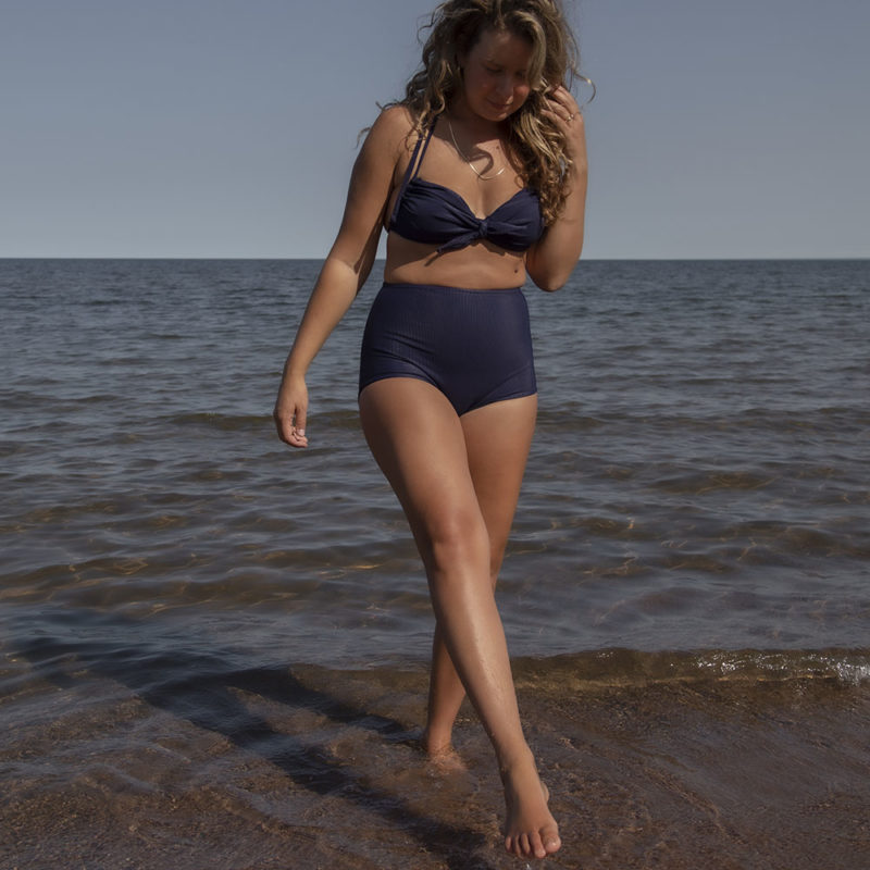 Front view of straight size model in Indigo Rib Retro Fit Bottoms standing in lake.