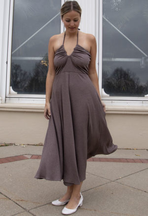 Front view of a straight size model in the Mauve Rib Everything Tank Dress, standing, standing outside in front of large windows.