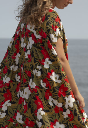 Side view of straight size model in Island Floral Double V Tiered Maxi Dress standing on beach with lake in background.