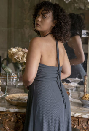 Back view of a straight size model in the Blue Spruce Rib Everything Tank Dress, standing in front of ornate table.