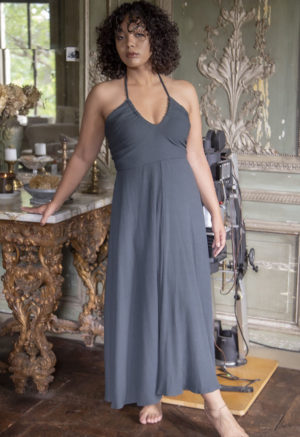 Front view of a straight size model in the Blue Spruce Rib Everything Tank Dress, standing in next ornate table.