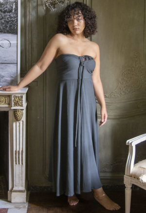 Front view of a straight size model in the Blue Spruce Rib Everything Tank Dress, standing in next to fireplace.