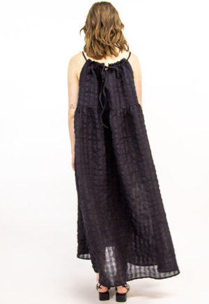 Back view of straight size model wearing Black Reversible Tie Dress.