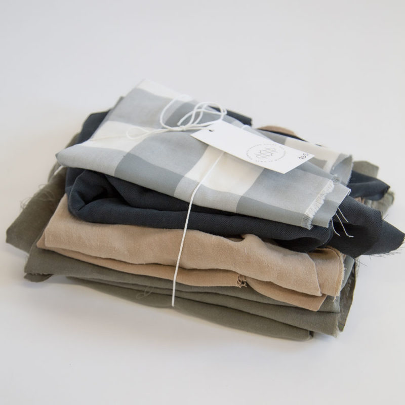 Quilt Scraps including Green Plaid, Liquorice, Latte Linen and Moss Linen.