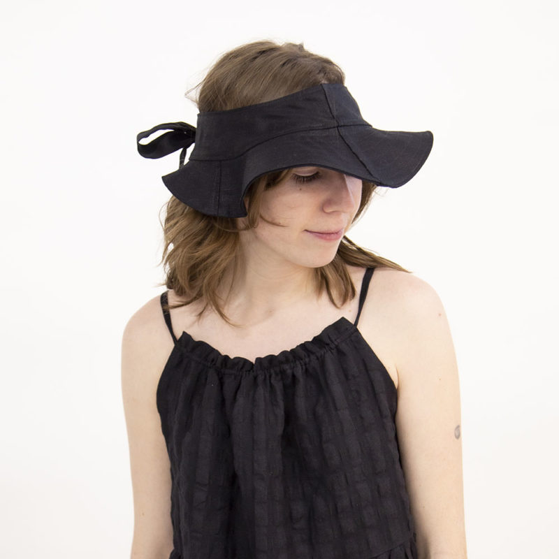 Front view of straight size model wearing Black Tie Visor Hat.