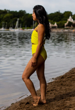Side view of straight size model wearing Margarita Wrap Top and Margarita High-Waisted Bikini Bottoms standing on shoreline.