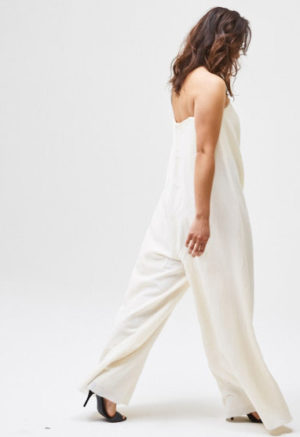 Side/back view of straight size model wearing White Ella Jumper.