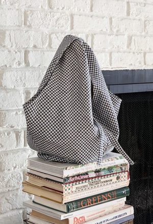 Dark Teal Blue Gingham Everyday Tote on stack of books
