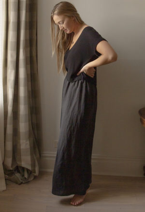 Side view of straight size model wearing Black Linen Extra Wide-Leg Pants.