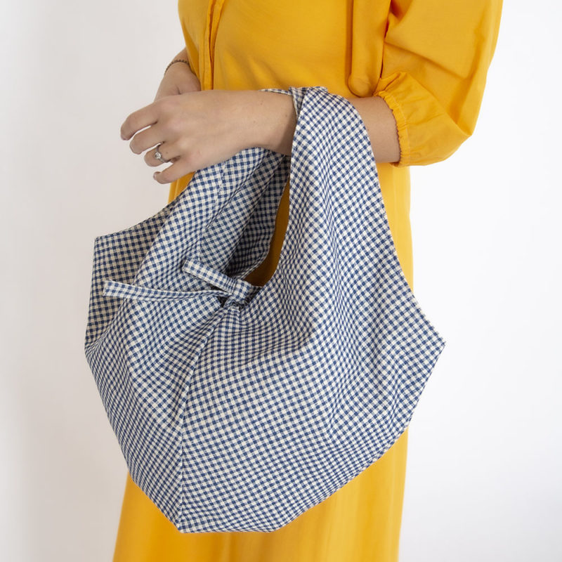 Straight size model holding Dark Teal Blue Gingham Everyday Tote.