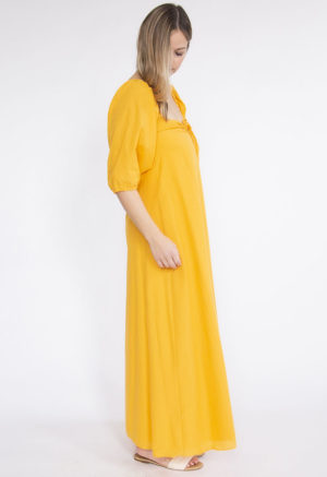 Side view of straight size model wearing Gold Keyhole Maxi Dress.