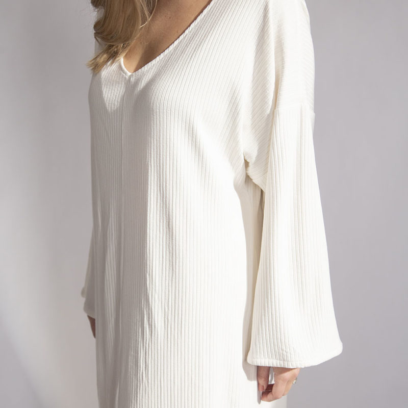 Close-up front view of straight size model wearing Ivory Rib Reversible Long Sleeve Maxi Dress.