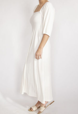 Side view of straight size model wearing Ivory Rib Square Neck Maxi Dress.