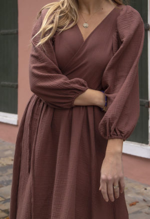 Close-up front view of straight size model wearing Raisin Gauze Reversible Wrap Dress.