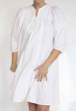 Front view of straight size model wearing White Babydoll Dress.