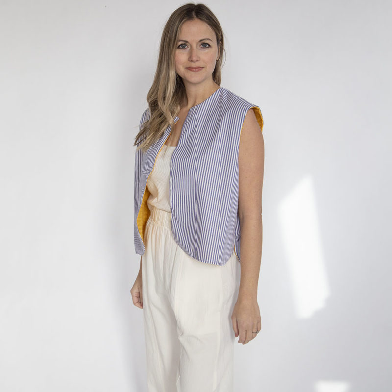 Front view of straight size model wearing Blue Stripe Reversible Vest.