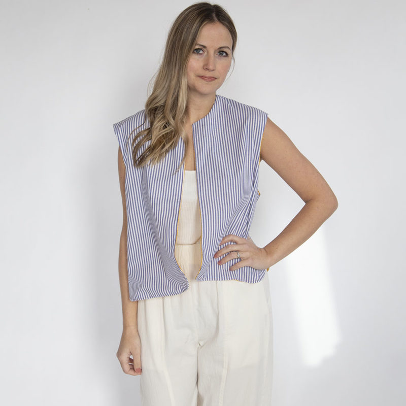 Front view of straight size model wearing Blue Stripe Reversible Vest.