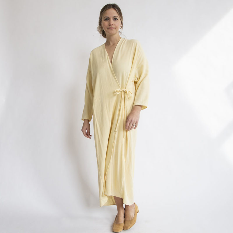 Front view of straight size model wearing Pale Yellow Gathered Wrap Dress.
