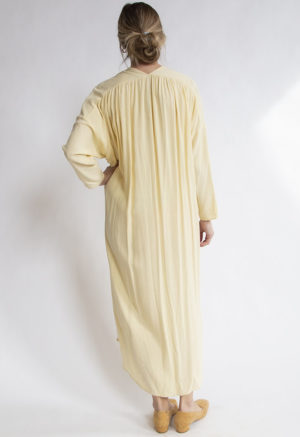Back view of straight size model wearing Pale Yellow Gathered Wrap Dress.