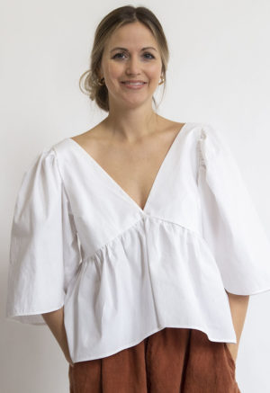 Front view of straight size model wearing White Ruffle Top.