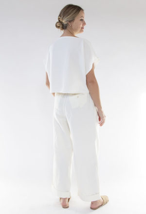 Back view of straight size model wearing Ivory Rib Cropped Rib Boatneck Top.