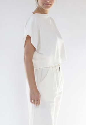 Side/front view of straight size model wearing Ivory Rib Cropped Rib Boatneck Top.