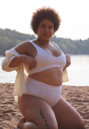Side view of plus size model wearing White Shoulder Tie Top.