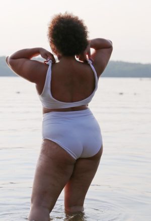 Back view of plus size model wearing White Shoulder Tie Top.