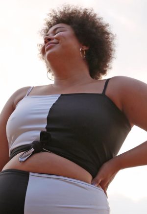 Front view of plus size model wearing Black & White Two-Tone Wrap Top.