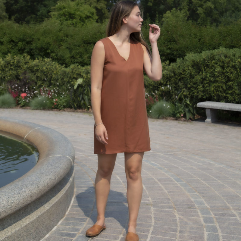 Front view of straight size model wearing Copper Lyocell Shift Dress.