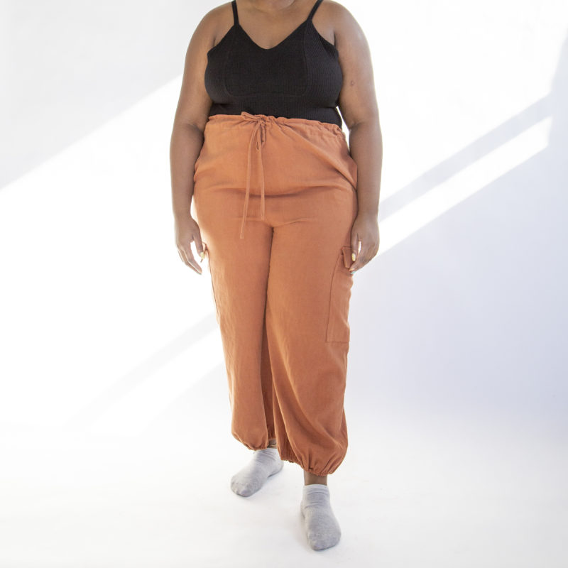 Front view of plus size model wearing Cinnamon Drawstring Cargo Pants.