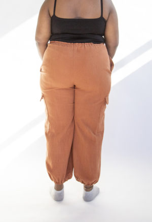 Back view of plus size model wearing Cinnamon Drawstring Cargo Pants.
