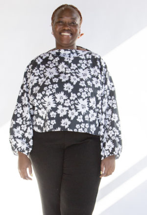 Front view of plus size model wearing Jungle Green Floral Cropped Boatneck Long-Sleeve Top.