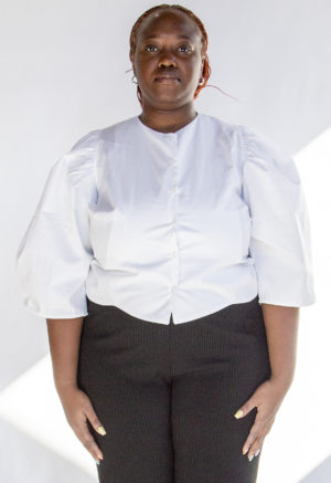 Front view of plus size model wearing White Puff-Sleeve Button-Down.