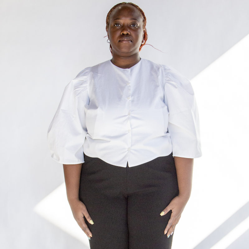 Front view of plus size model wearing White Puff-Sleeve Button-Down.