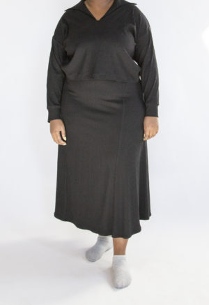 Front view of plus size model wearing Black Rib A-Line Midi Skirt.