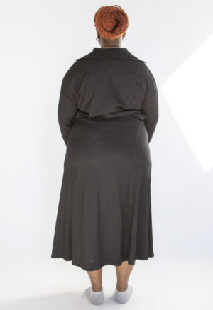 Back view of plus size model wearing Black Rib A-Line Midi Skirt.