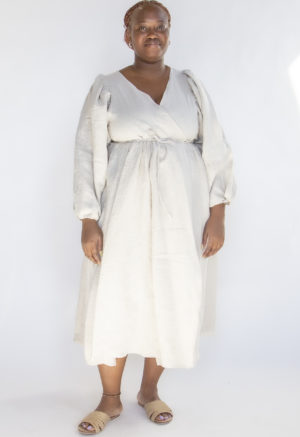 Front view of plus size model wearing Oatmeal Linen Reversible Wrap Dress.