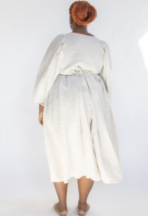 Back view of plus size model wearing Oatmeal Linen Reversible Wrap Dress.
