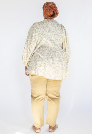 Back view of plus size model wearing Almond Floral Balloon Sleeve Tunic.