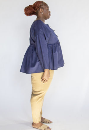 Side view of plus size model wearing Navy Reversible Tie Tunic.