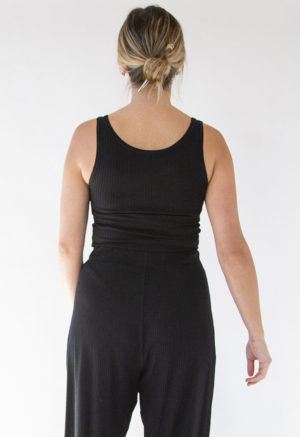 Back view of straight size model wearing Black Rib Reversible Scoop Bodysuit.