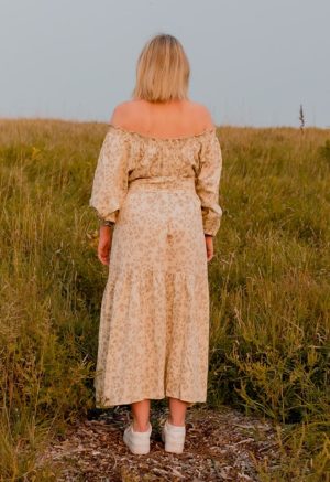Back view of straight size model wearing Almond Floral Pauline Maxi Dress.